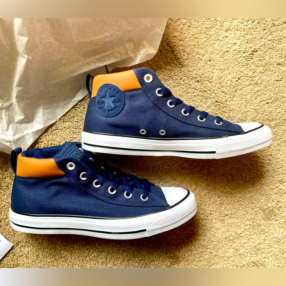 Navy canvas, tan leather, mid cut height Converse Chuck Taylor Allstar sneakers